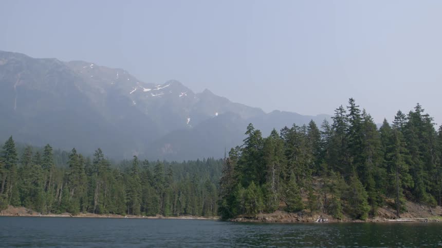 The mountain pas the lake is covered with fog