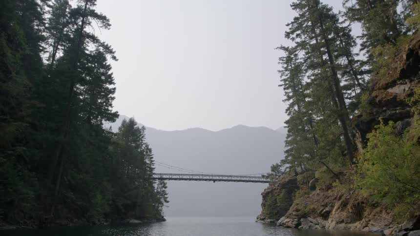 Bridge connecting two rock formations over a body of water