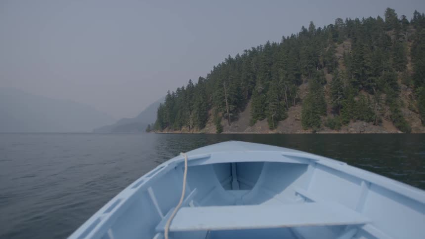A boat floats on a mountain lake