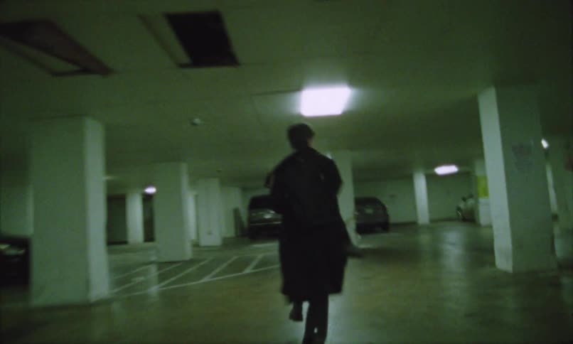 Man runs through a parking garage