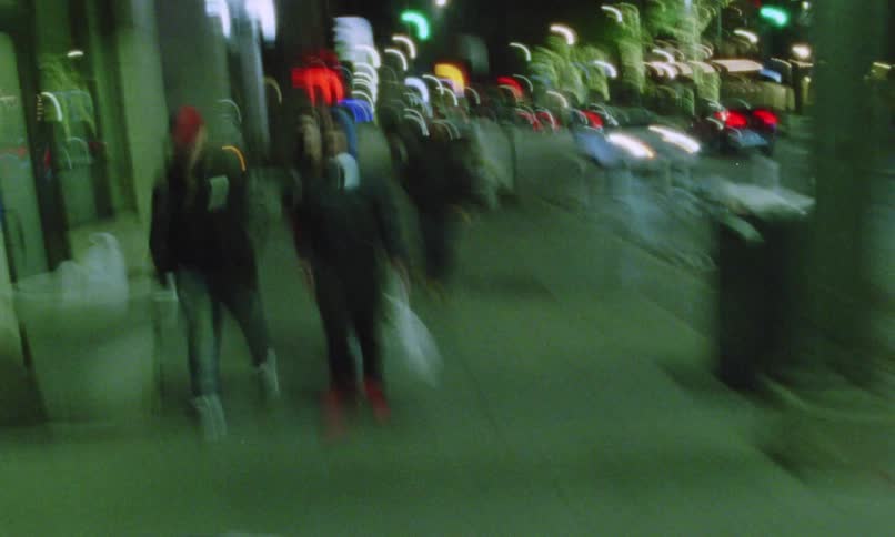 People walk around the city at night