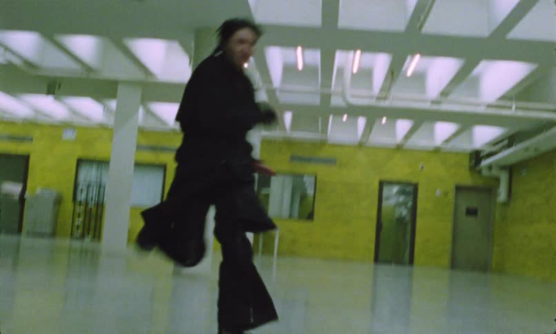 The woman chases a man through the building