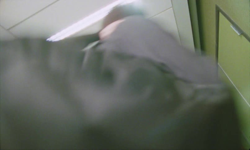 The man and woman are shoving each other and fighting in the hall