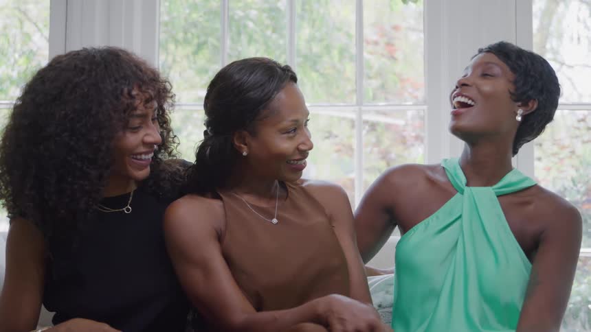 Three happy women talking and laughing
