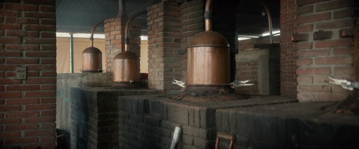 Smoke rises from one of the ovens in a manufacturing center during the daytime