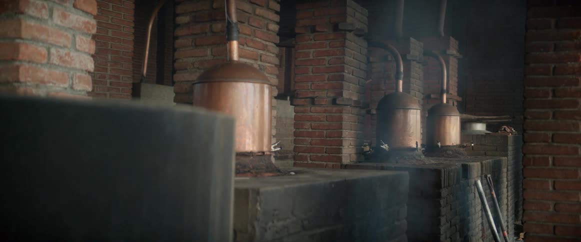 A distillery with several cylindrical pieces of equipment used for brewing beer