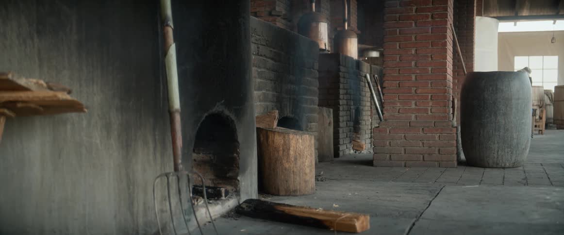 Rustic setting with brick ovens barrels and tools leaning against the wall