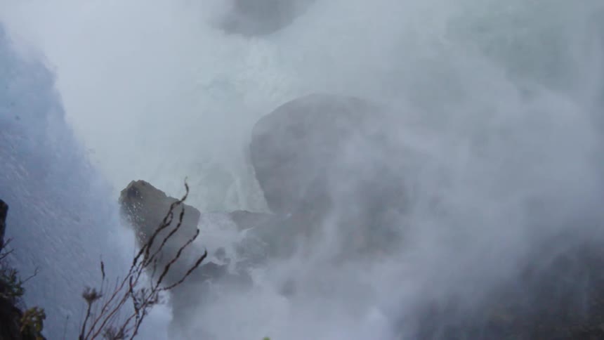 The waterfall crashes into the rocks