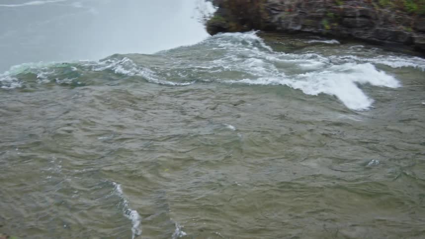 A water stream flowing down a waterfall outdoors during daytime