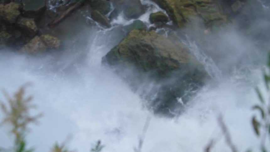 A rocky waterfall in the jungle at midday