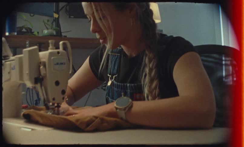 A young woman sewing with a sewing machine
