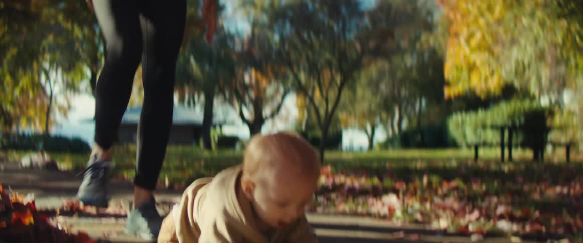The baby falls and her mother picks him up