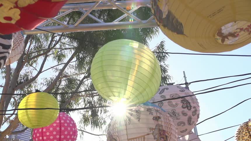 Photo of some paper lamps tied to lines