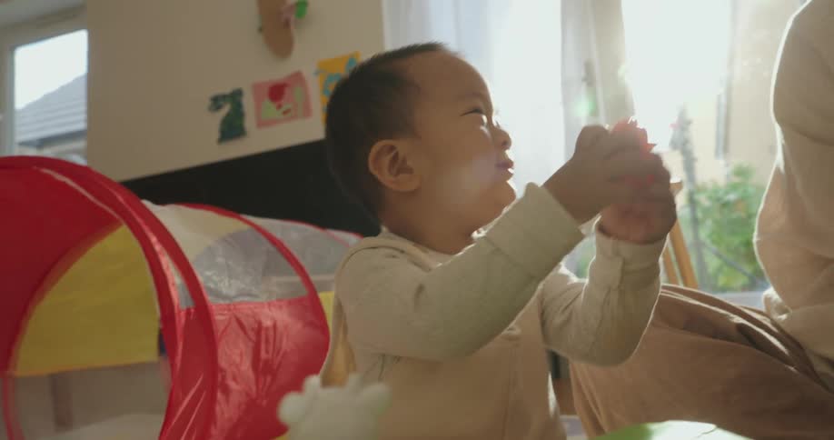 Child playing with colorful toys in a brightly lit room
