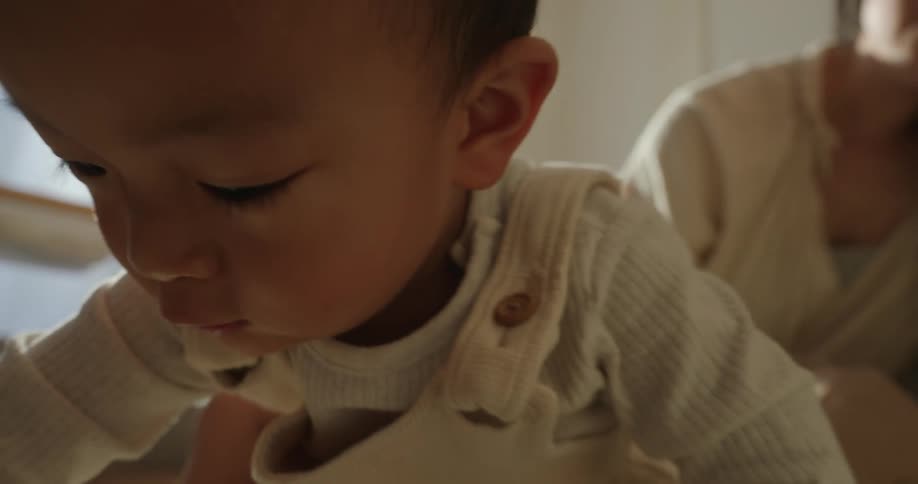 Mother and toddler playing with toys inside a room