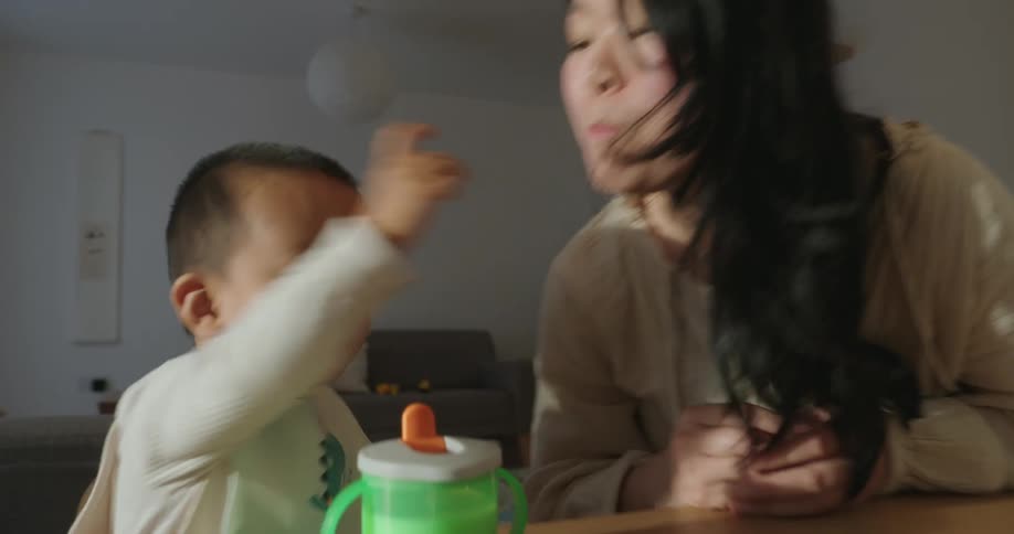 A young child feeding their mother and then eating as well