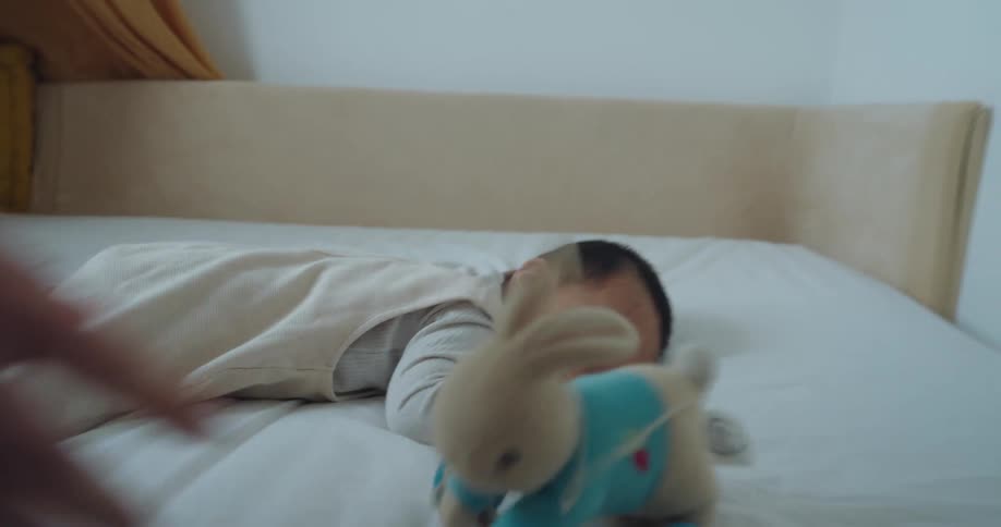 A mother is trying to get her son to lay down for a nap