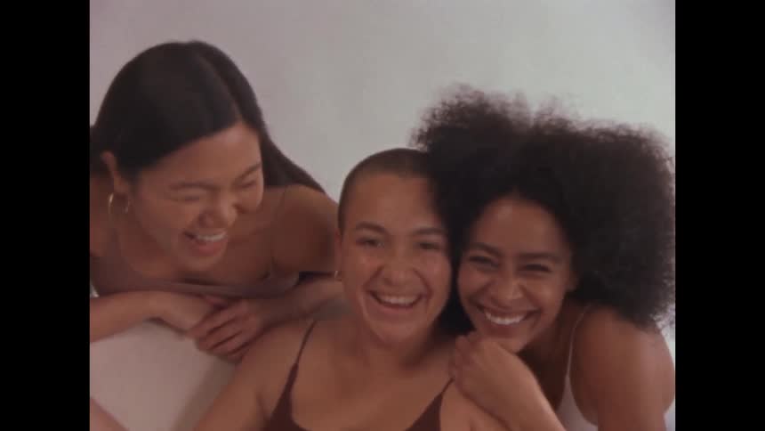 Portrait of a group of young happy female friends in a room