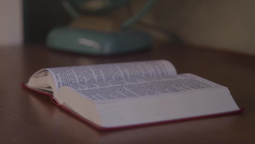 A fan blows the pages of a book