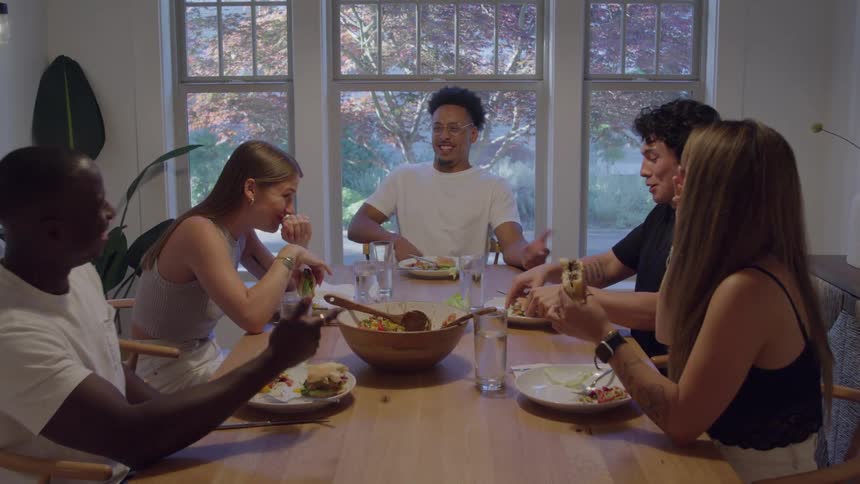 Friends share laughter while having a meal together
