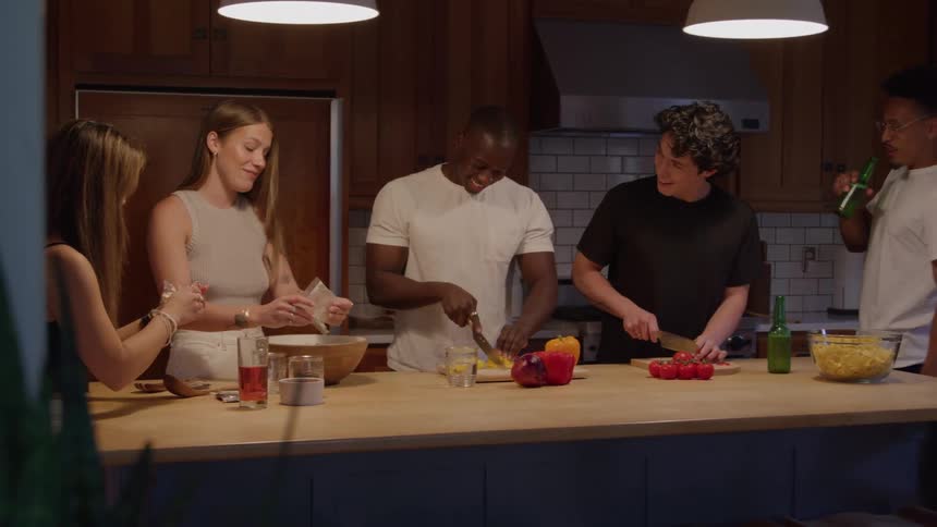 A group of people is preparing a meal in a kitchen