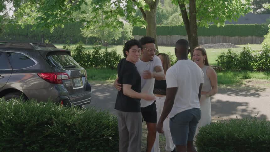 Couple walks to the street to greet their friends as they arrive