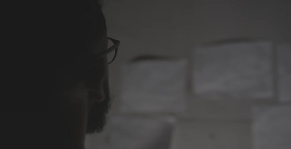 A man looks at papers on the wall
