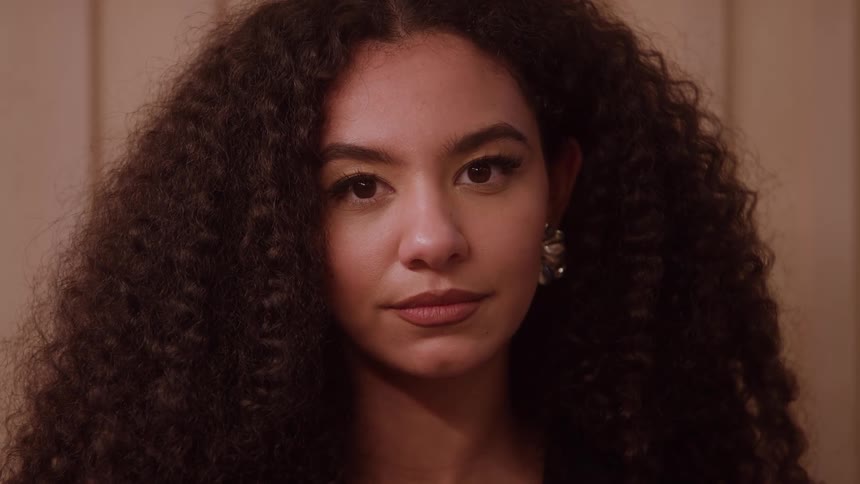 The face of a young woman who was looking to her left and then staring straight ahead
