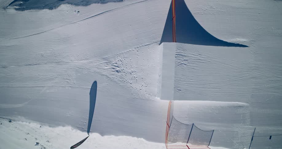 A man skiing on the snow on a sunny day