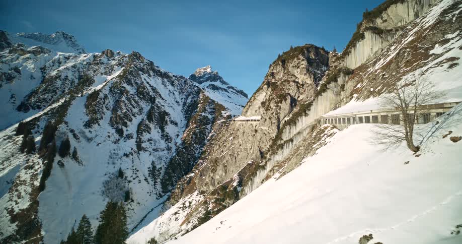 Aerial view of some snow on mountains with a car gallery