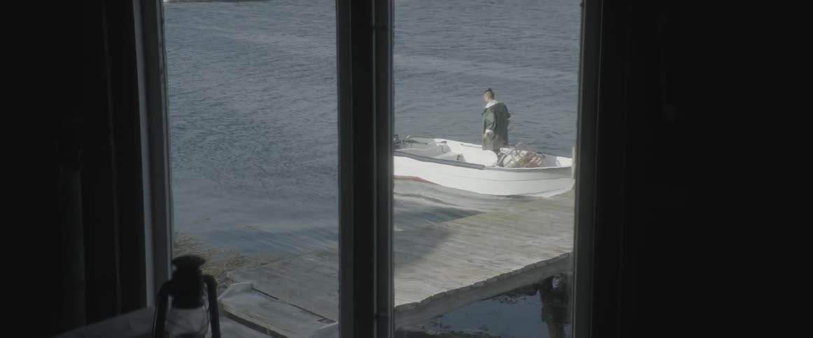 Man gets into a small boat at a dock