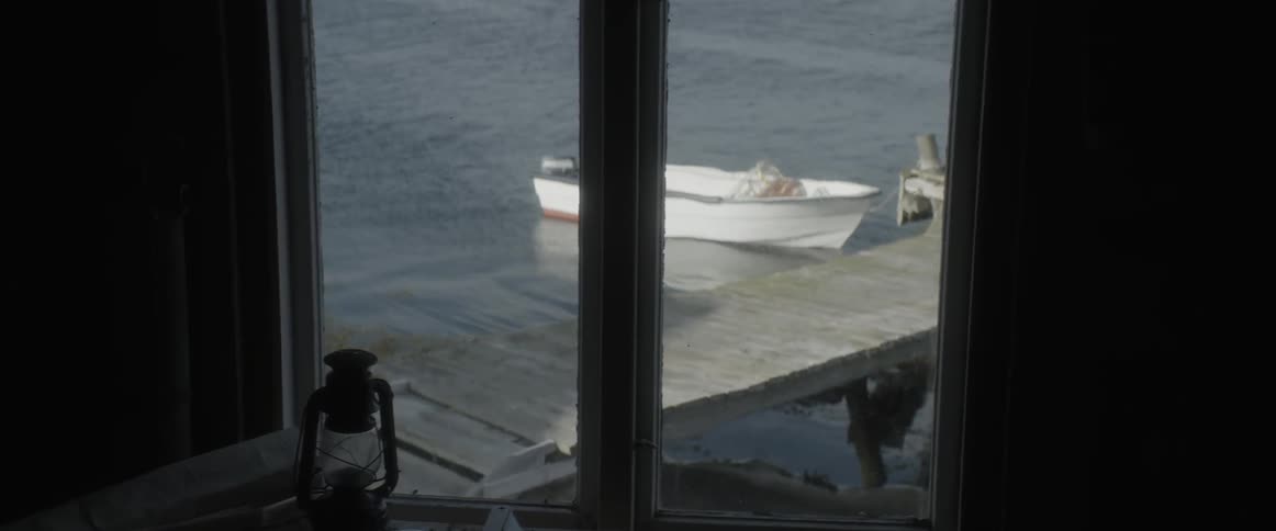 Looking out of a window at a boat on the water