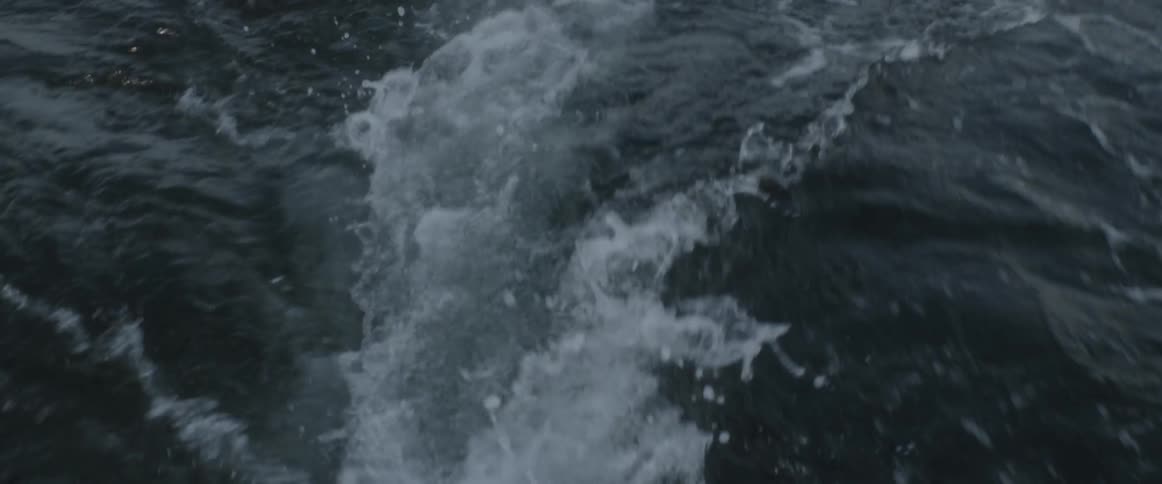 Water churns behind a boat
