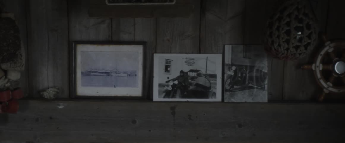 Black-and-white photos sitting on a mantle