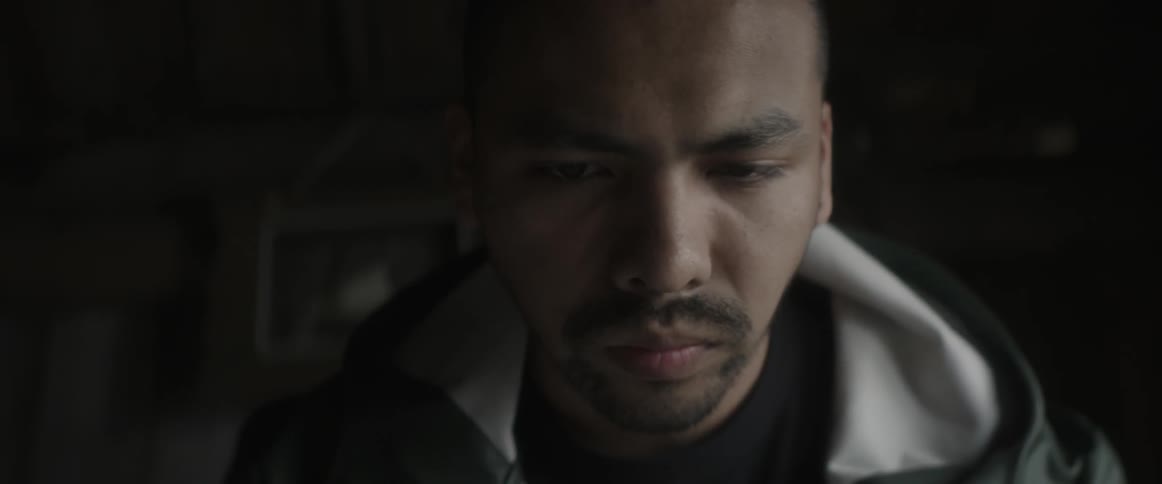 A man looks around in a dark room