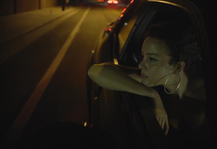 Woman sitting in a car looking out the window