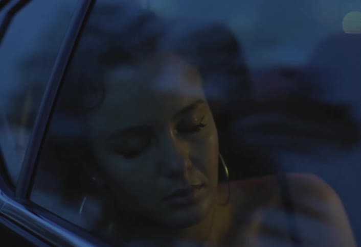 A woman sleeping while riding in a car