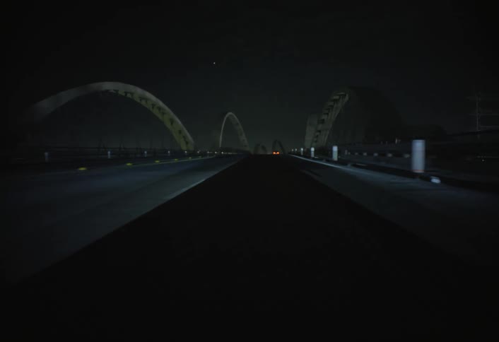 A car driving down a road at night