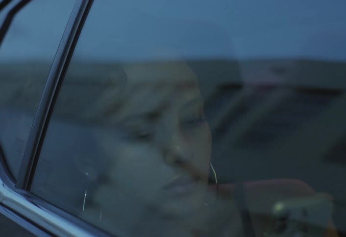 A woman sleeping in a car