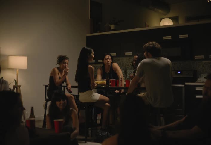 Friends enjoy themselves at a house party at night