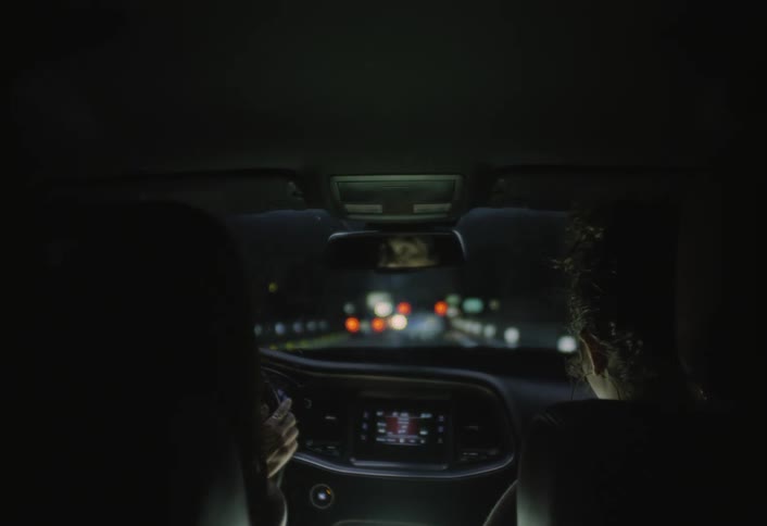 Two women in a car driving at night