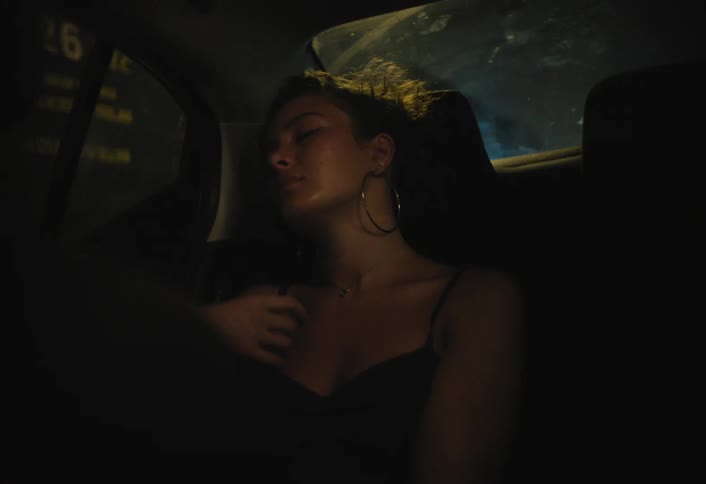 A woman is relaxing as she rides in a car