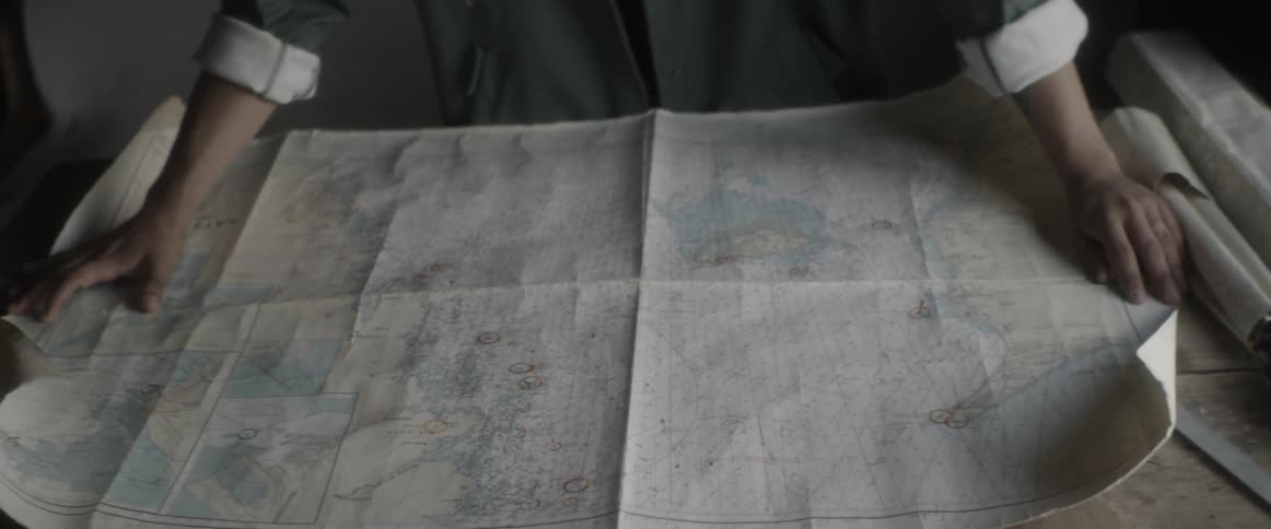 A man rolls out a map