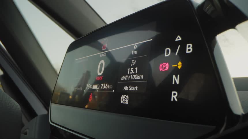An adult exits from the backseat of a selfdriving car with an electronic dashboard