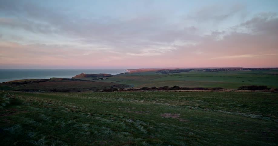 Open rural land overlooking the coast at sunset