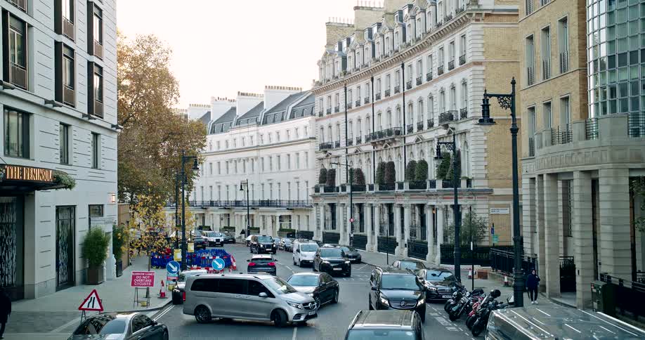 Aerial of a busy street filled with multiple vehicles in a metropolitan city during daytime
