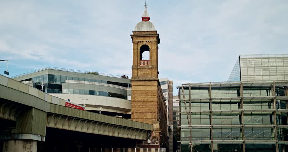 Old brick tower contrasts with modern buildings around it