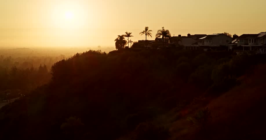 Aerial of a suburban landscape on a highland area at sunset