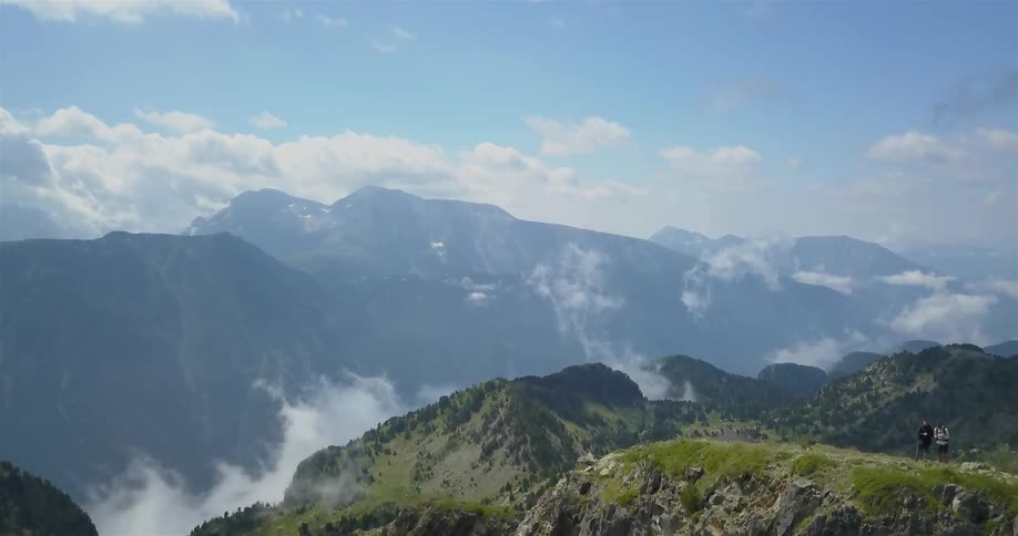 Mountains covered in fog on a partly cloudy day