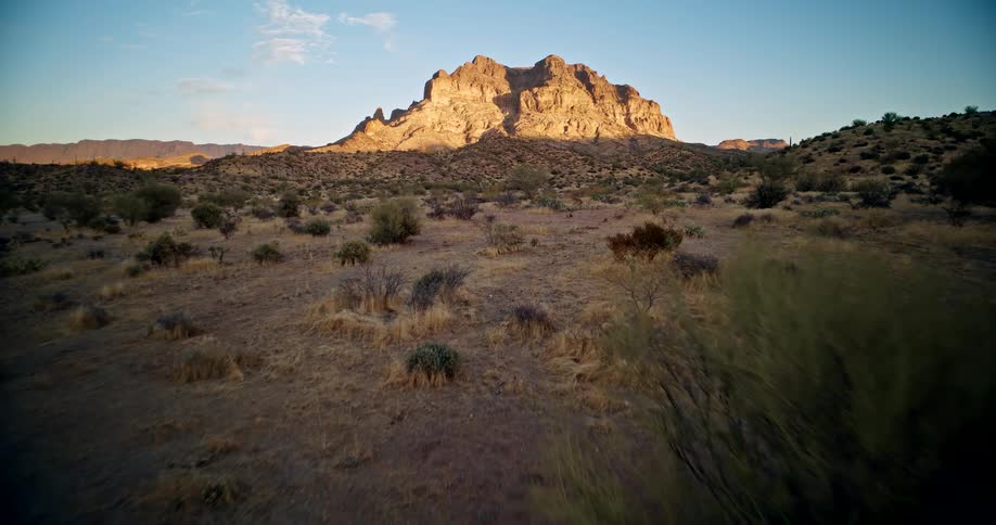 Aerial of a desert area filled with sparse vegetation during daytime